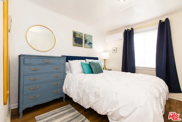 a bedroom with a bed and a mirror