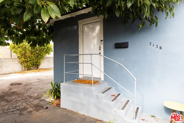 a backyard of a house with table and chairs