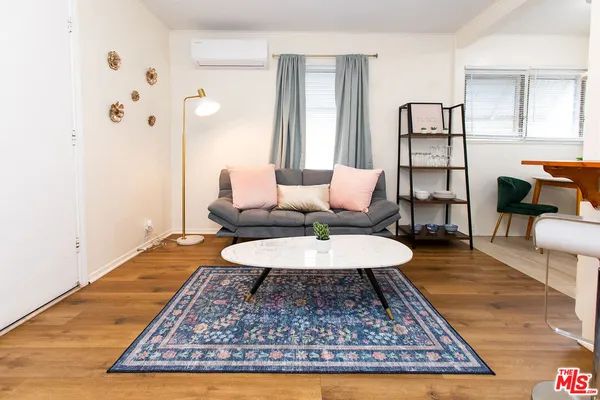 a living room with furniture and a rug