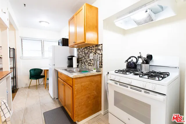 a kitchen with a stove and cabinets