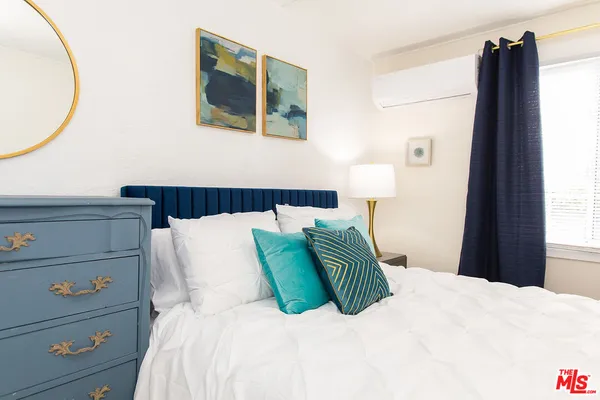 a bedroom with a bed and a mirror