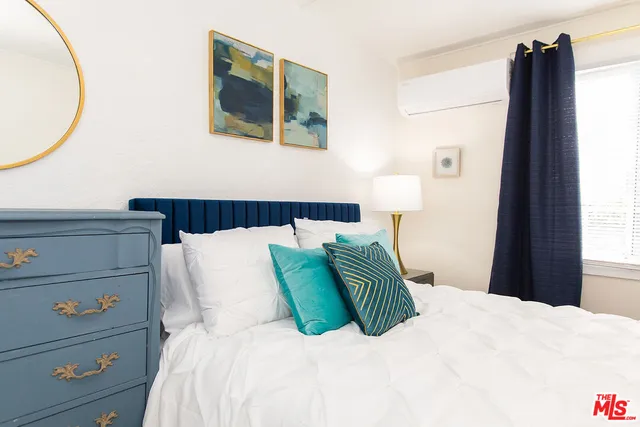 a bedroom with a bed and a mirror