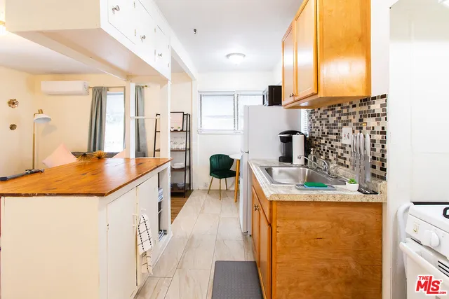 a kitchen with a sink stove and refrigerator