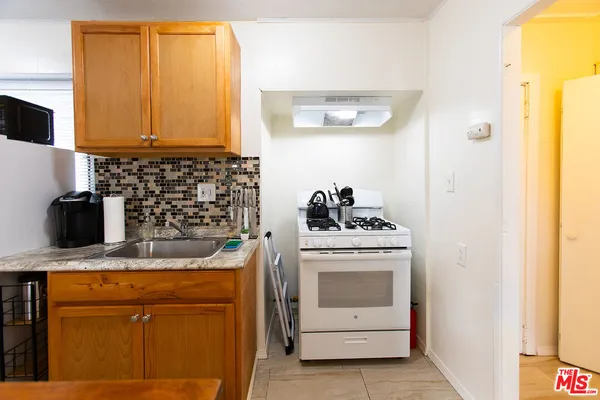 a kitchen with a stove and a microwave