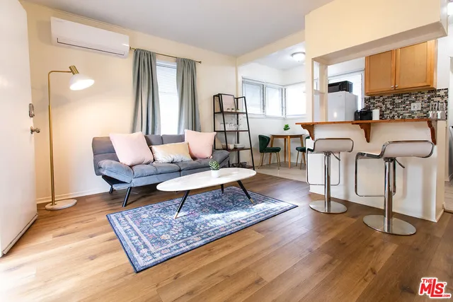 a living room with furniture rug and wooden floor