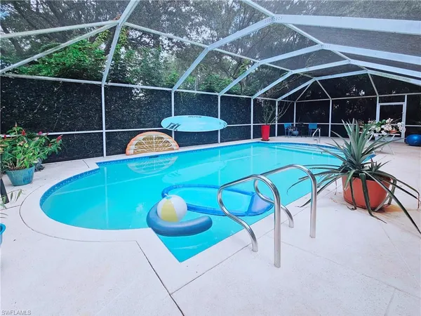 a view of a swimming pool with a seating space