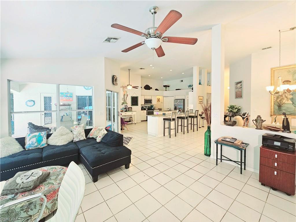 6708 Sloane Place Naples, FL 34104 - Photo 12 of 31 a living room with furniture and a large window