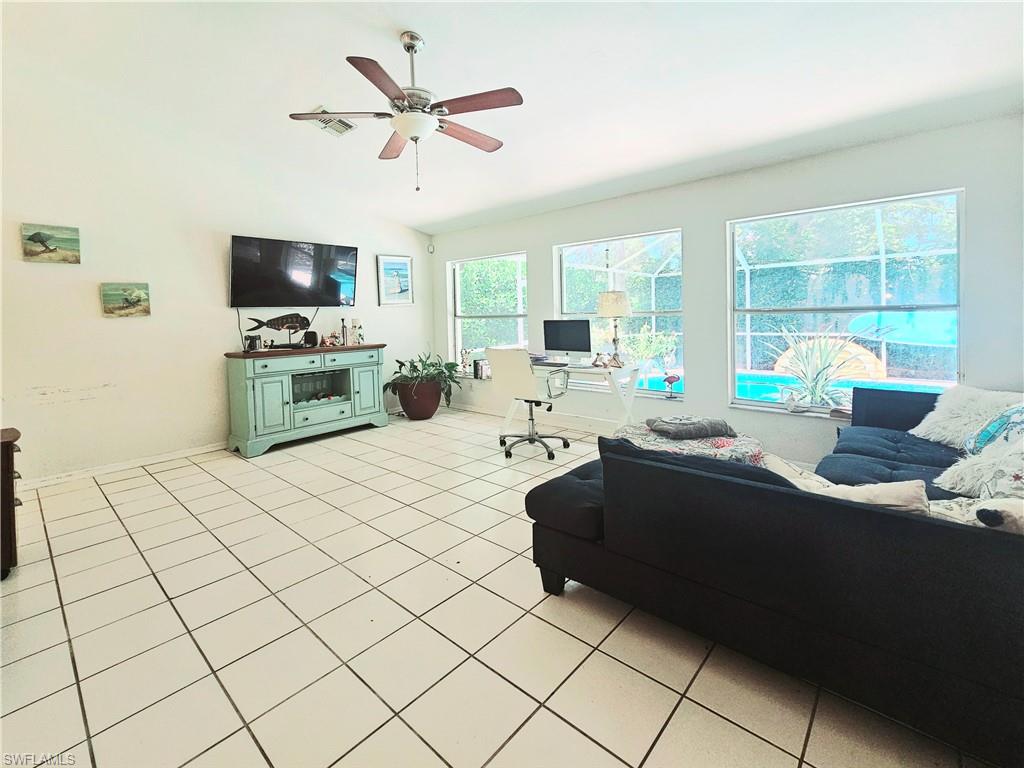 6708 Sloane Place Naples, FL 34104 - Photo 13 of 31 a living room with furniture and a flat screen tv