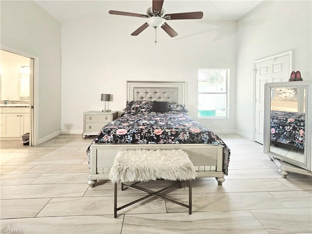 6708 Sloane Place Naples, FL 34104 - Photo 15 of 31 a living room with a bed furniture and a window