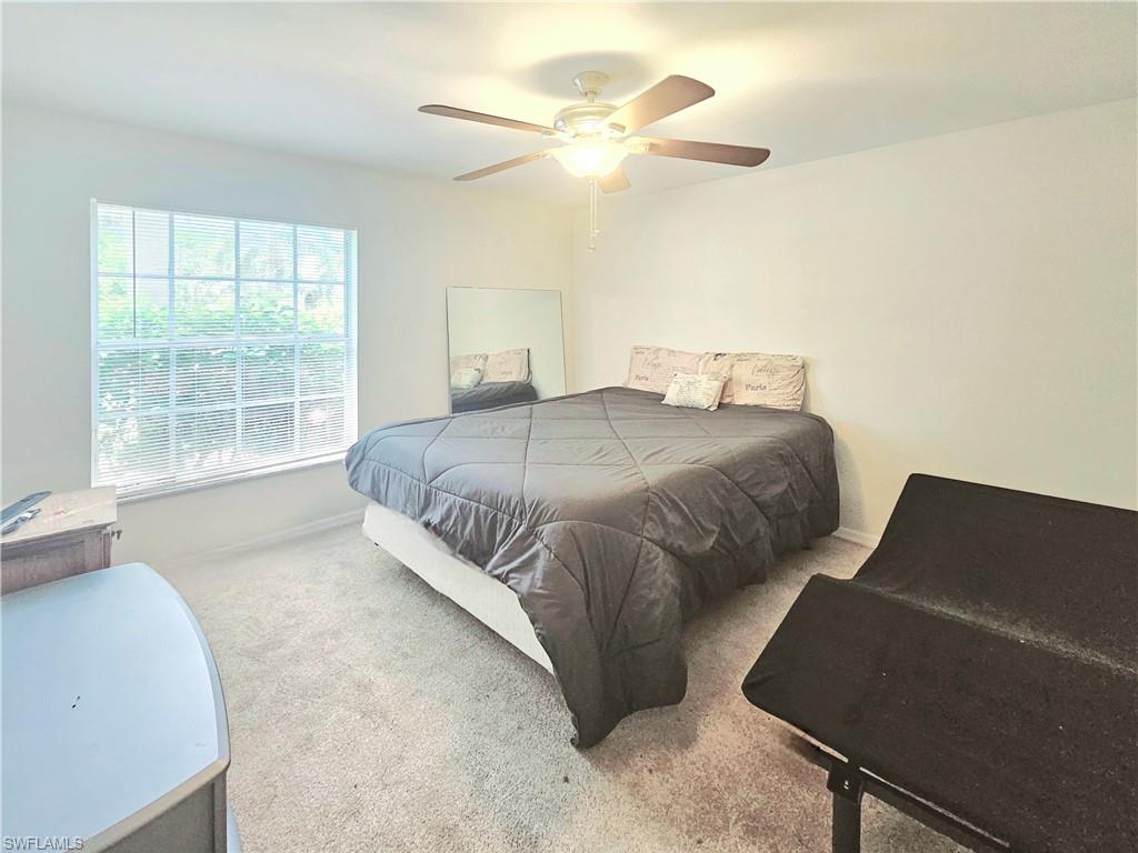 6708 Sloane Place Naples, FL 34104 - Photo 20 of 31 a spacious bedroom with a bed and a window