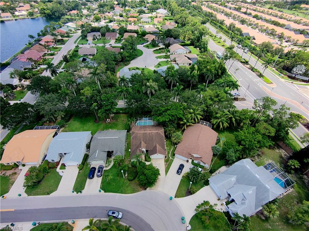 6708 Sloane Place Naples, FL 34104 - Photo 25 of 31 an aerial view of multiple houses with yard