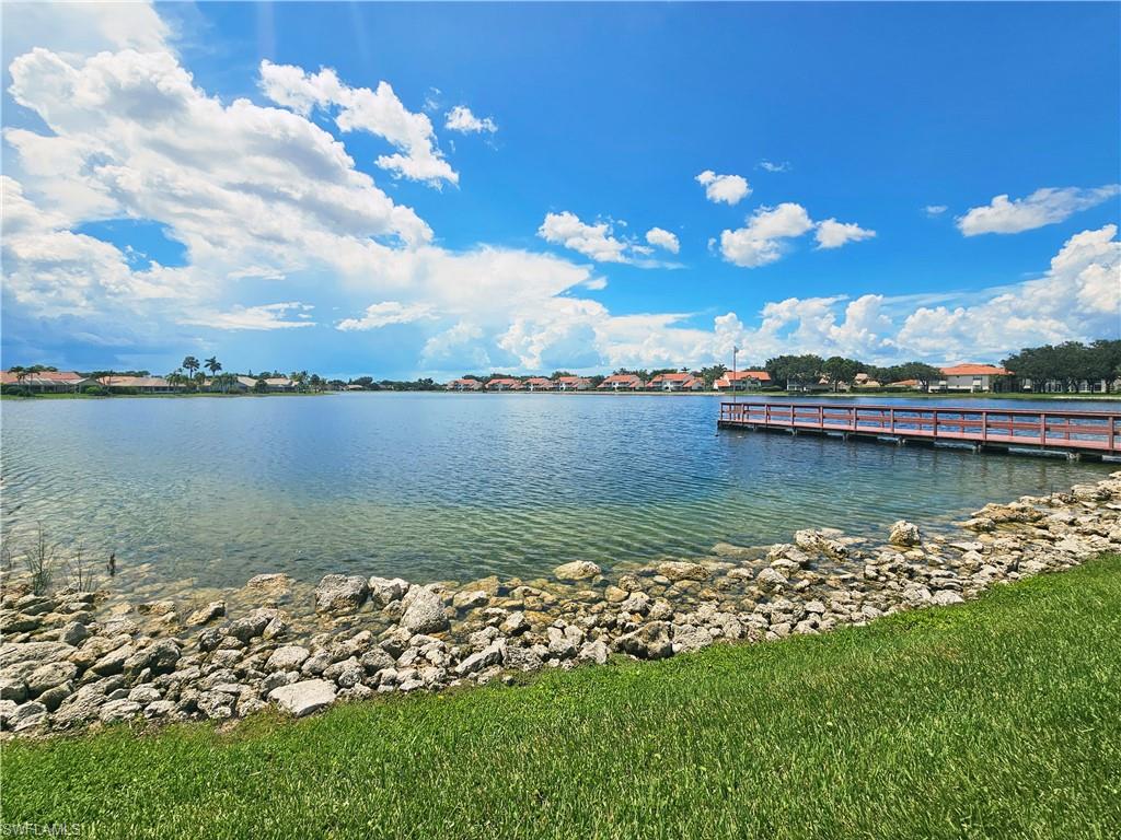 6708 Sloane Place Naples, FL 34104 - Photo 27 of 31 a view of a lake with houses in the back