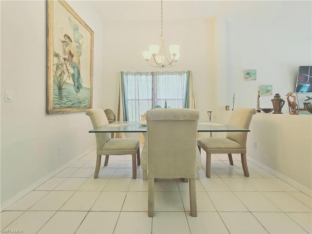 6708 Sloane Place Naples, FL 34104 - Photo 9 of 31 a dining room with furniture and window