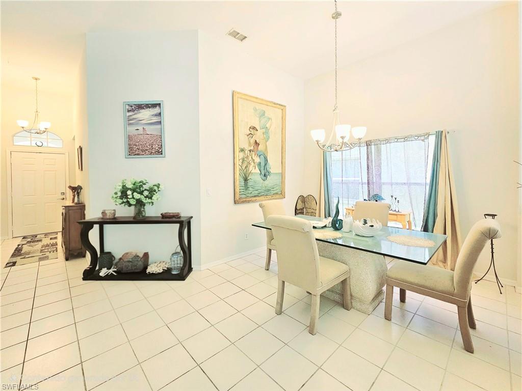 6708 Sloane Place Naples, FL 34104 - Photo 10 of 31 a living room with furniture and a table