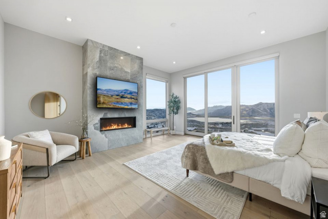 2002 East Outlaw Road Kamas, UT 84036 - Photo 36 of 65 Spacious room featuring wood-finish flooring and a stone-clad fireplace with an integrated linear firebox