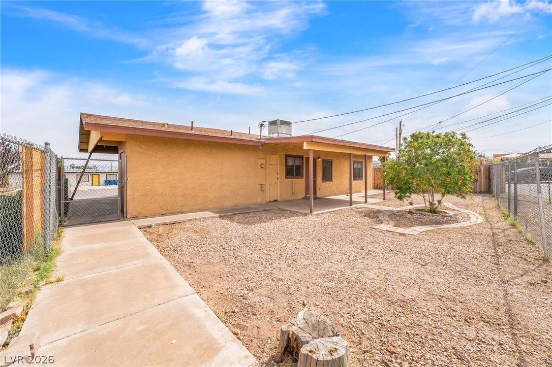 242 Nebraska Avenue Henderson, NV 89015 - Photo 30 of 46 Rear view of property with a fenced backyard, stucco siding, a gate, and a patio area