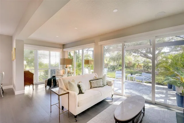 a living room with furniture and a large window with outer view