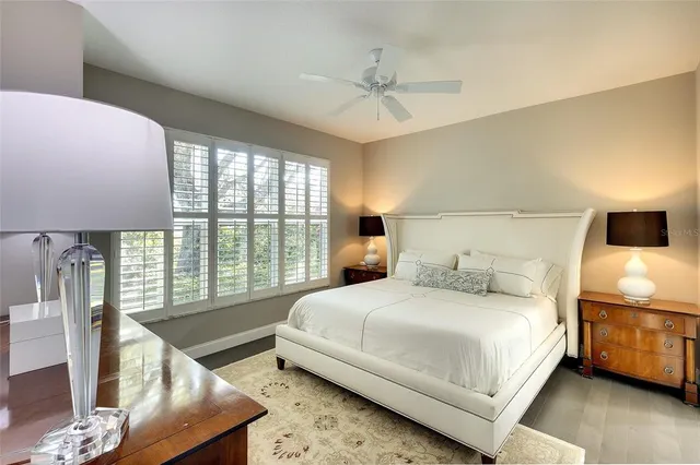 a bedroom with a large bed and a large window