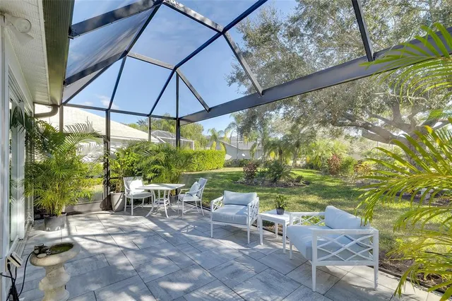 a view of a patio with table and chairs under an umbrella