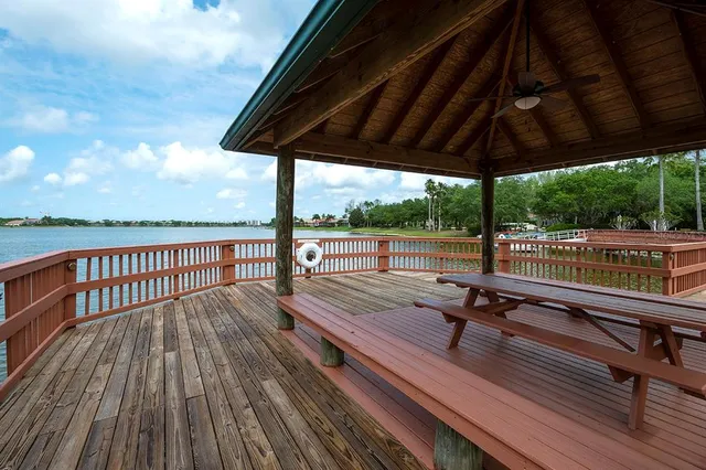 a view of a wooden deck with furniture