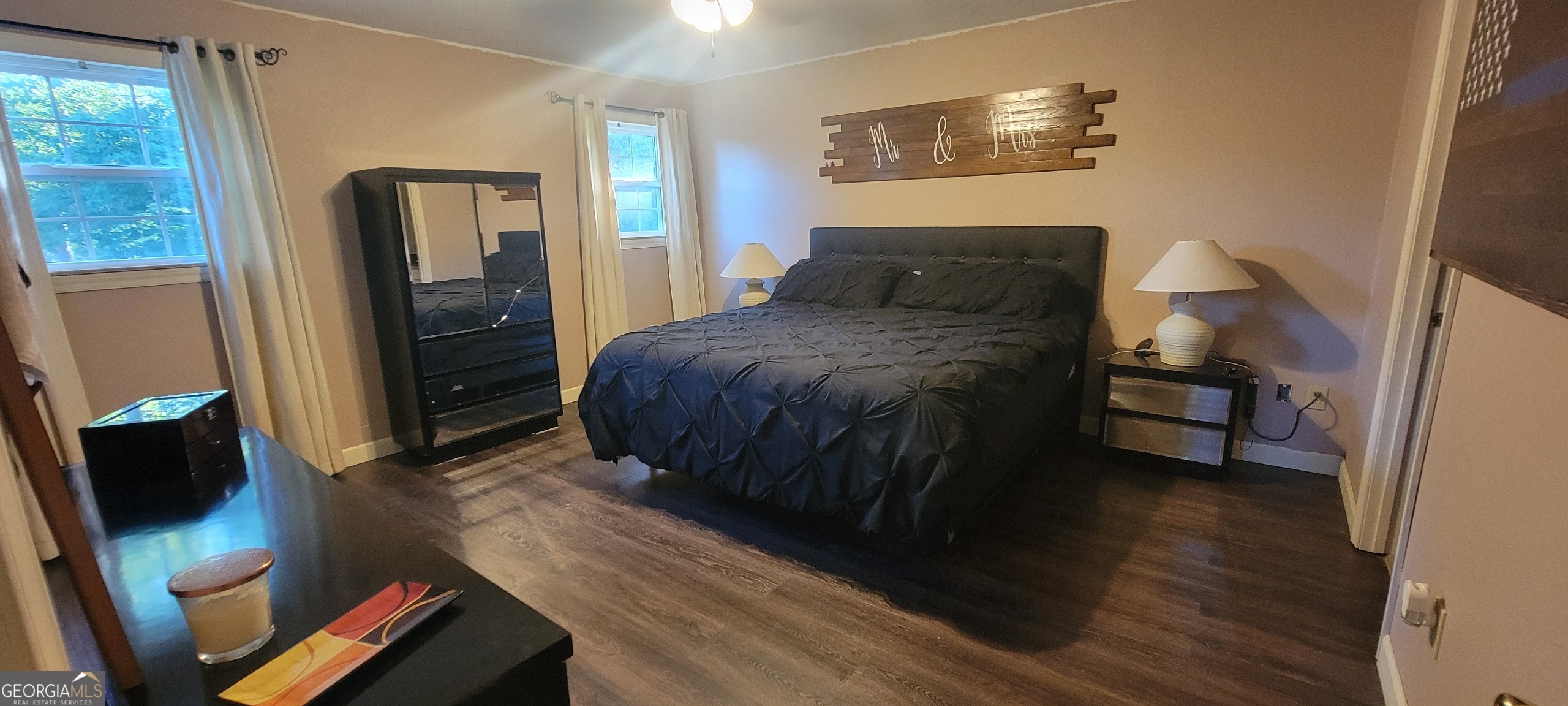 1605 Cody Road Mount Airy, GA 30563 - Photo 12 of 26 a bedroom with a bed and wooden floor