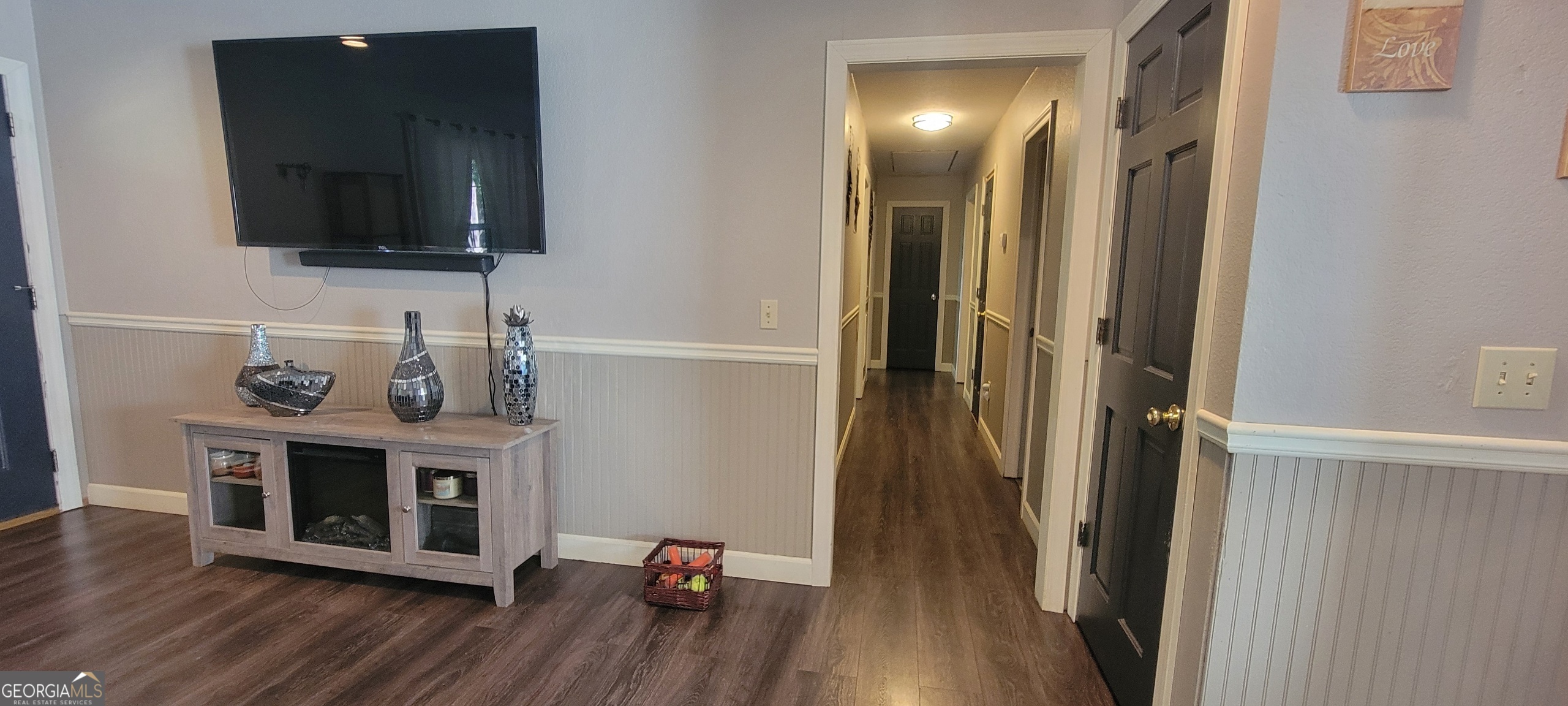 1605 Cody Road Mount Airy, GA 30563 - Photo 17 of 26 a view of a livingroom with wooden floor and a flat screen tv