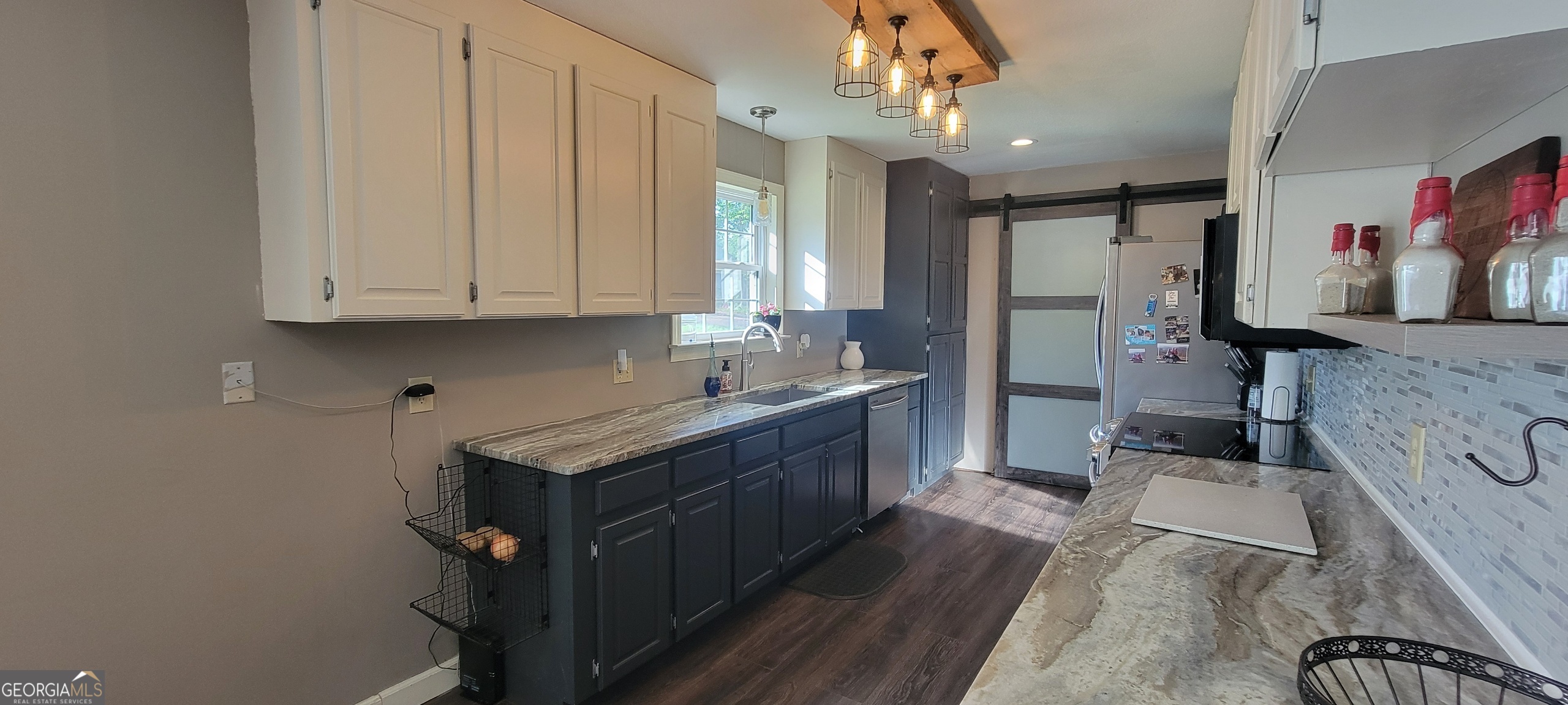 1605 Cody Road Mount Airy, GA 30563 - Photo 6 of 26 a kitchen with stainless steel appliances granite countertop a stove a sink dishwasher and cabinets with wooden floor