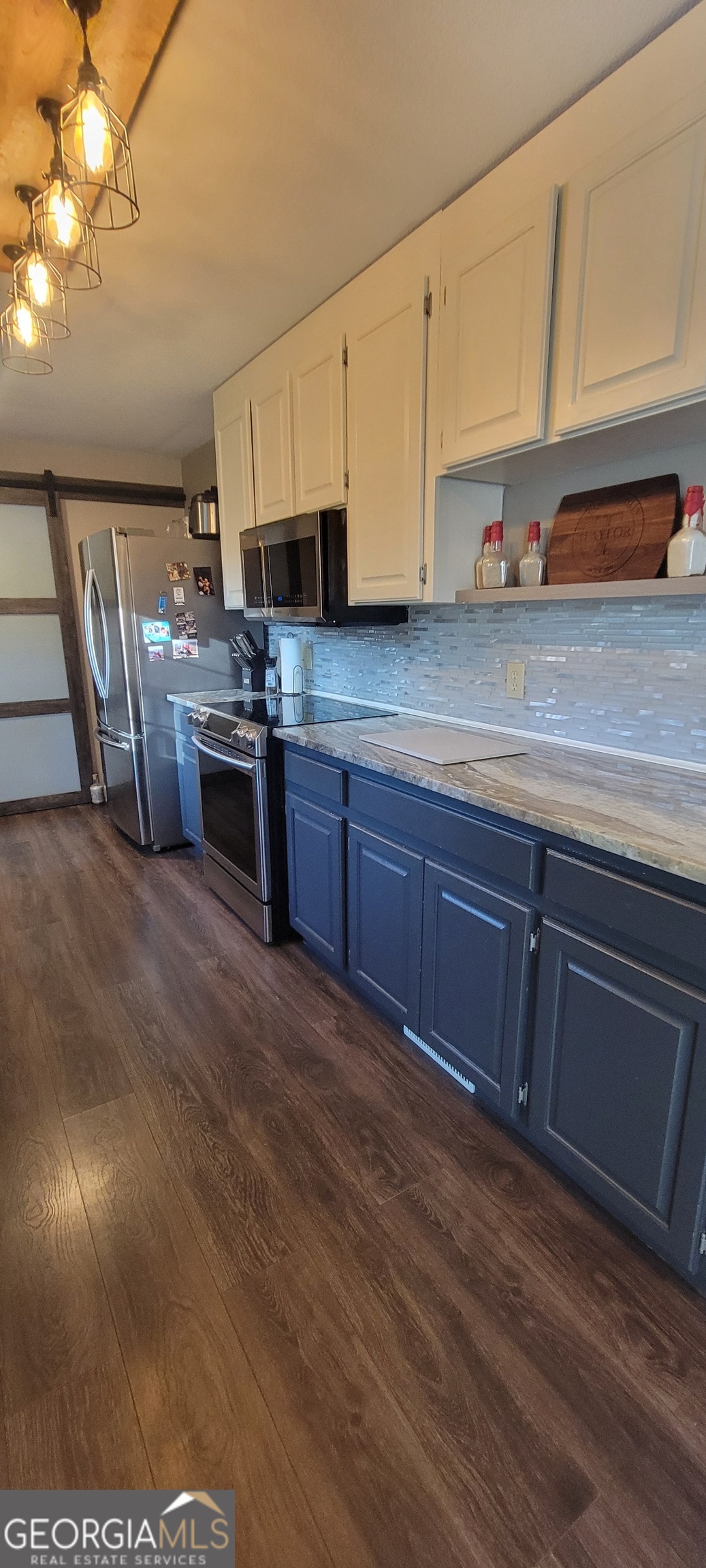 1605 Cody Road Mount Airy, GA 30563 - Photo 7 of 26 a kitchen with stainless steel appliances granite countertop a sink a stove cabinets and wooden floor
