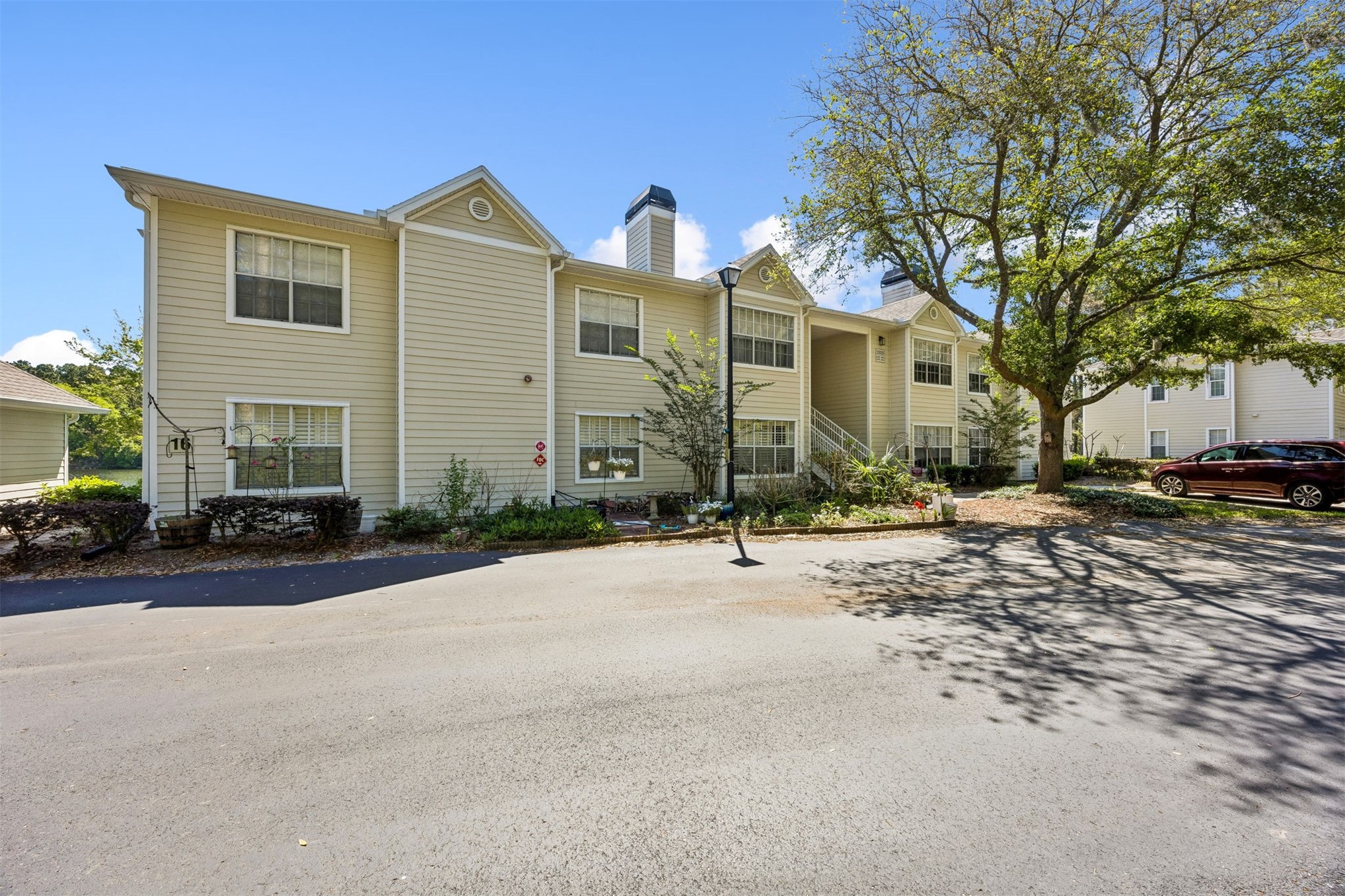 23525 Bahama Point, Unit 1621 Fernandina Beach, FL 32034 - Photo 1 of 68 a front view of a house with a yard and potted plants