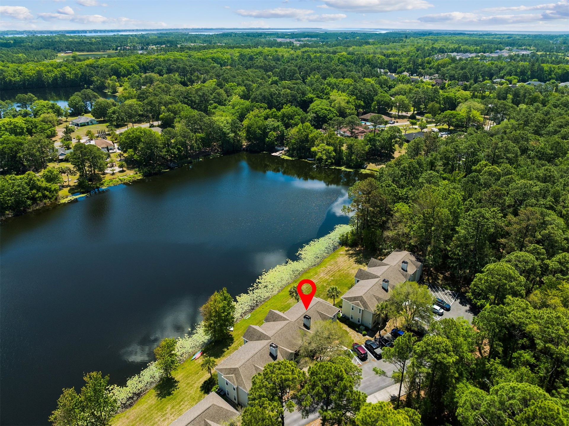 23525 Bahama Point, Unit 1621 Fernandina Beach, FL 32034 - Photo 38 of 68 an aerial view of a house with a yard and lake view