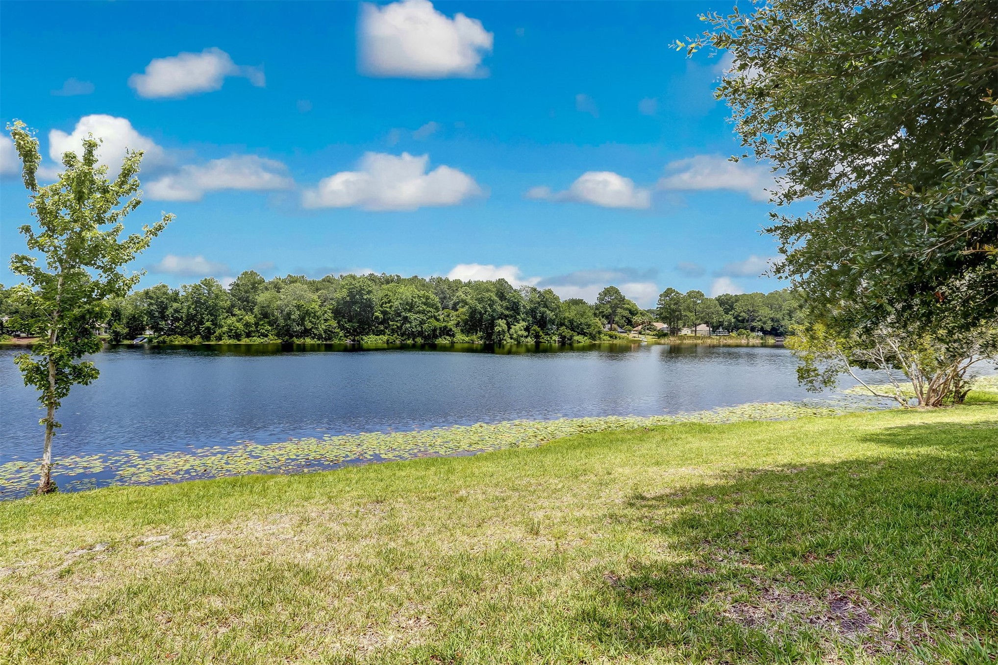 23525 Bahama Point, Unit 1621 Fernandina Beach, FL 32034 - Photo 62 of 68 a view of a lake from a yard