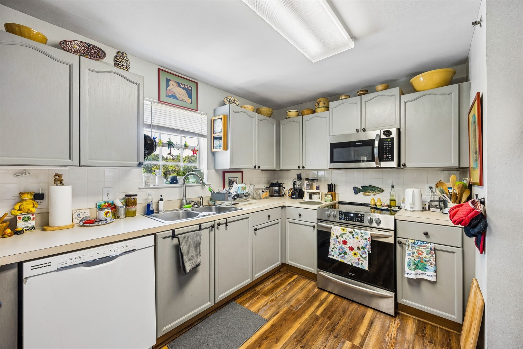 23525 Bahama Point, Unit 1621 Fernandina Beach, FL 32034 - Photo 10 of 68 a kitchen with stainless steel appliances granite countertop a sink dishwasher stove top oven and cabinets with wooden floor