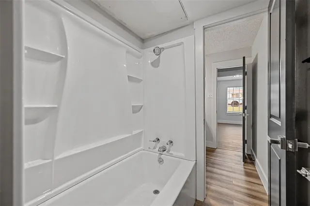 a bathroom with a bathtub and a shower
