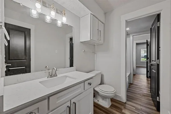 a bathroom with a toilet a sink and mirror