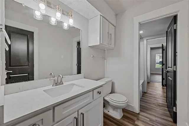 a bathroom with a toilet a sink and mirror