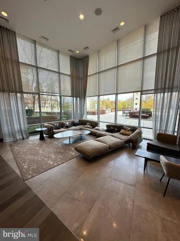 a living room with lots of furniture and a large window