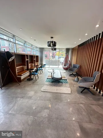 a living room with furniture a air conditioner and a window