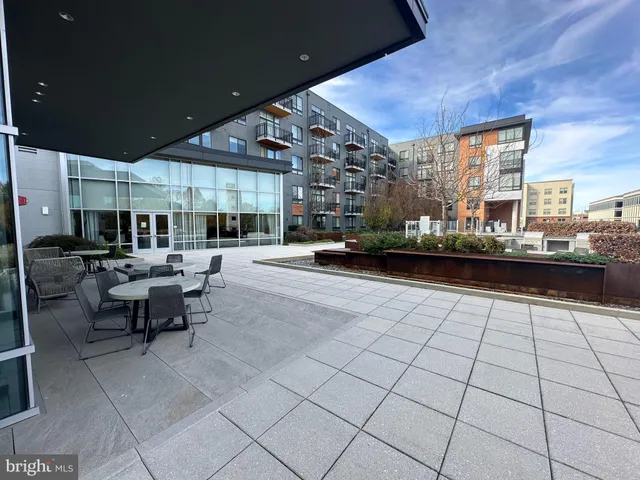 a living room with lots of furniture and kitchen view