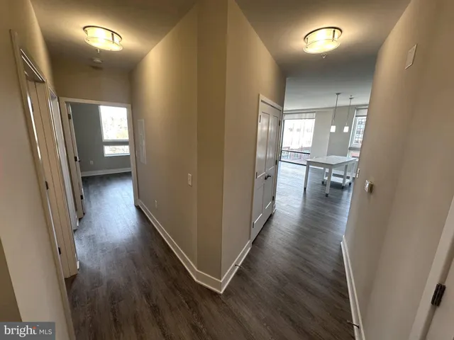 a view of a hallway with wooden floor