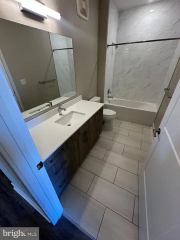 a bathroom with a sink vanity and a mirror