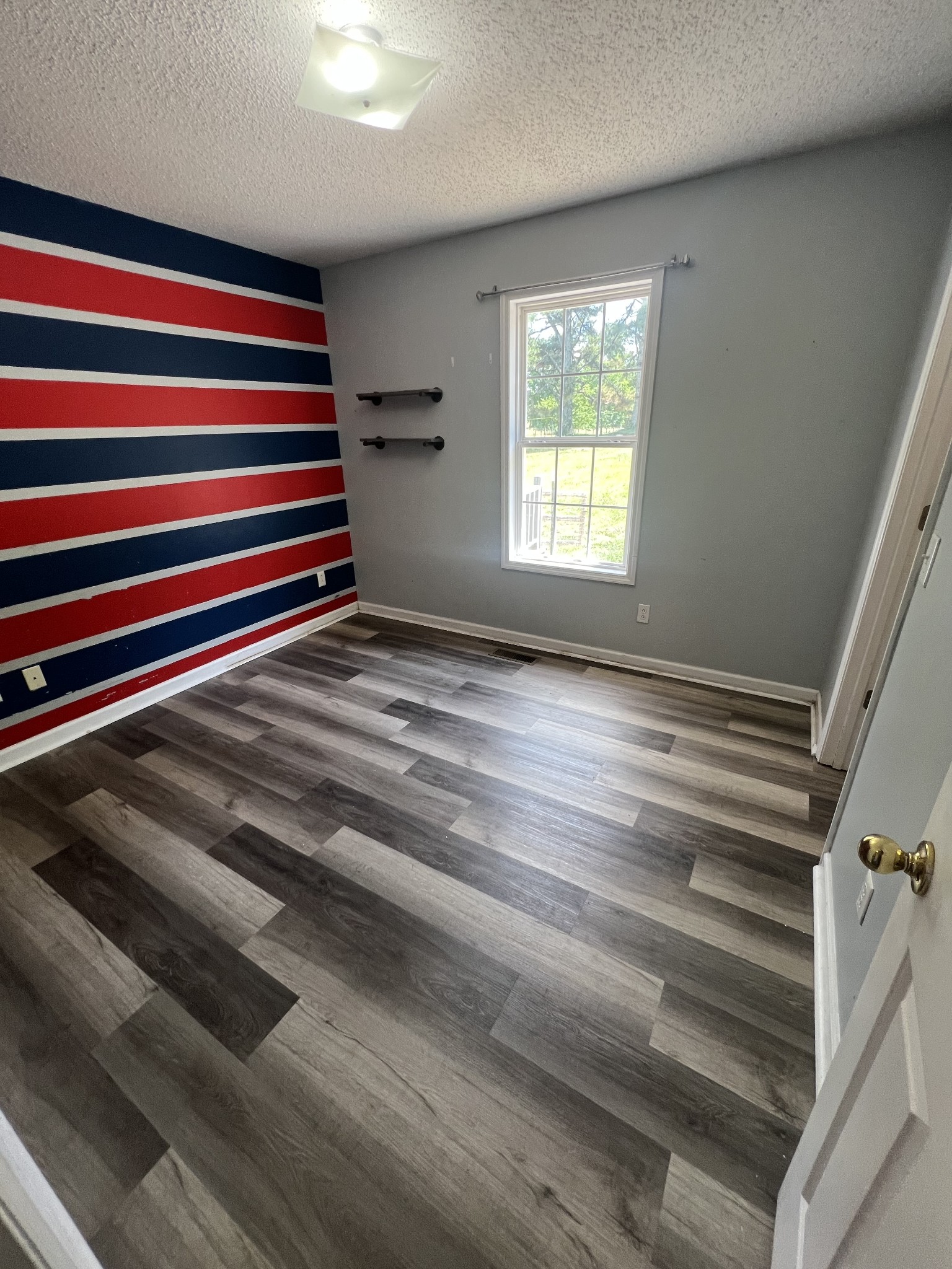 149 Hawthorne Street Pulaski, TN 38478 - Photo 19 of 33 a view of empty room with wooden floor and fan