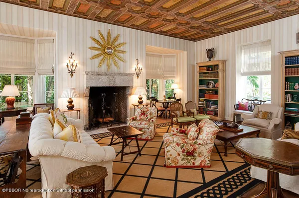 a living room with furniture a fireplace and a table