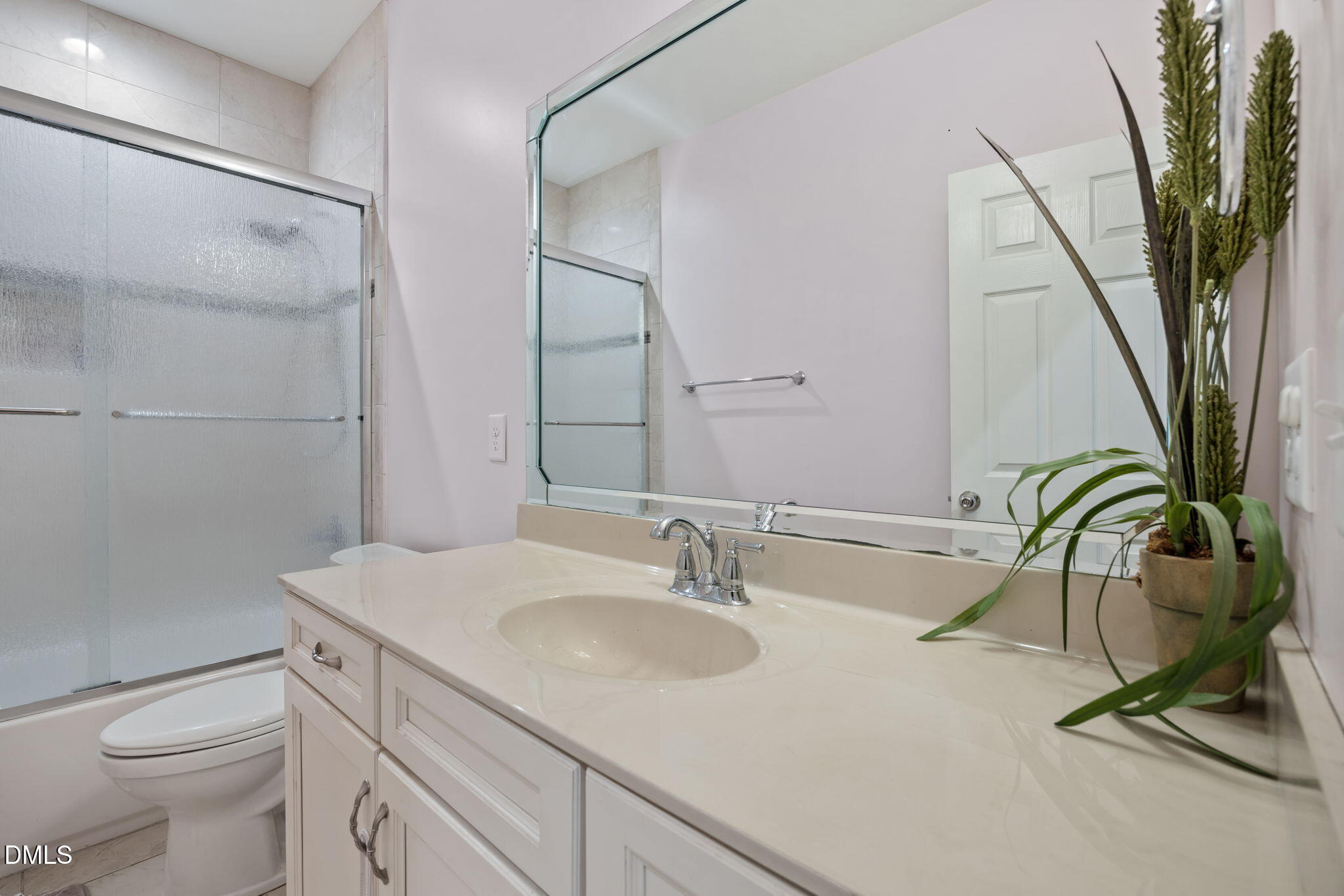 2880 Elevation Road Four Oaks, NC 27524 - Photo 29 of 51 a bathroom with a sink a toilet and a mirror