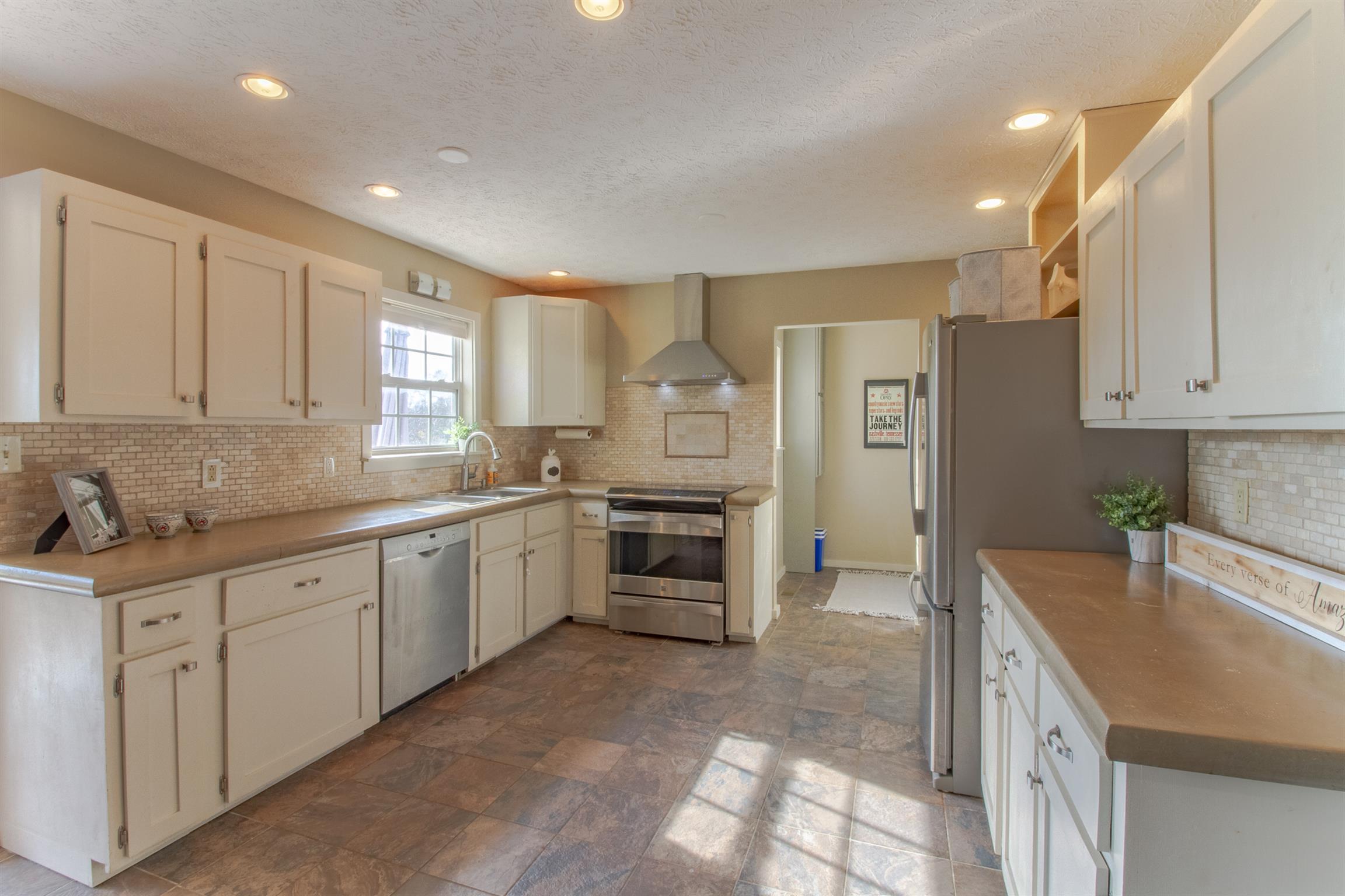 6990 Hoods Branch Road Springfield, TN 37172 - Photo 11 of 23 a kitchen with granite countertop a sink cabinets and stainless steel appliances