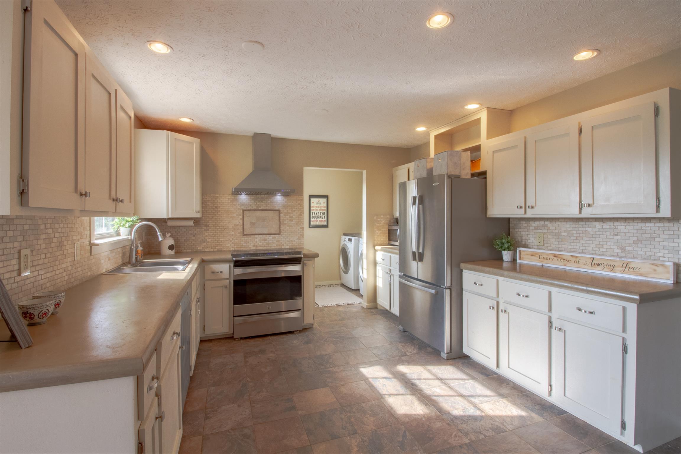 6990 Hoods Branch Road Springfield, TN 37172 - Photo 12 of 23 a kitchen with stainless steel appliances a stove a sink and a refrigerator