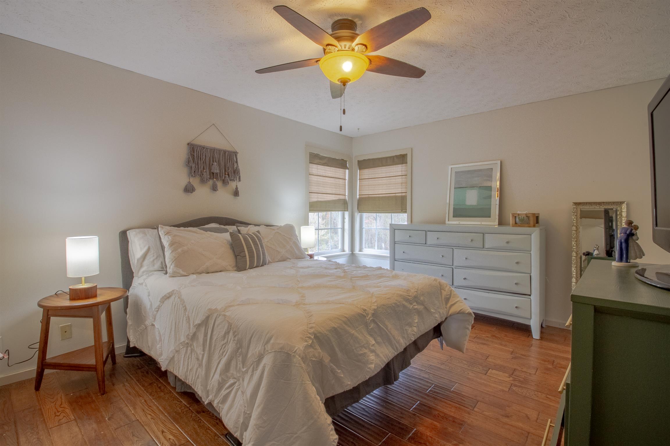 6990 Hoods Branch Road Springfield, TN 37172 - Photo 16 of 23 a bedroom with a bed and a chandelier
