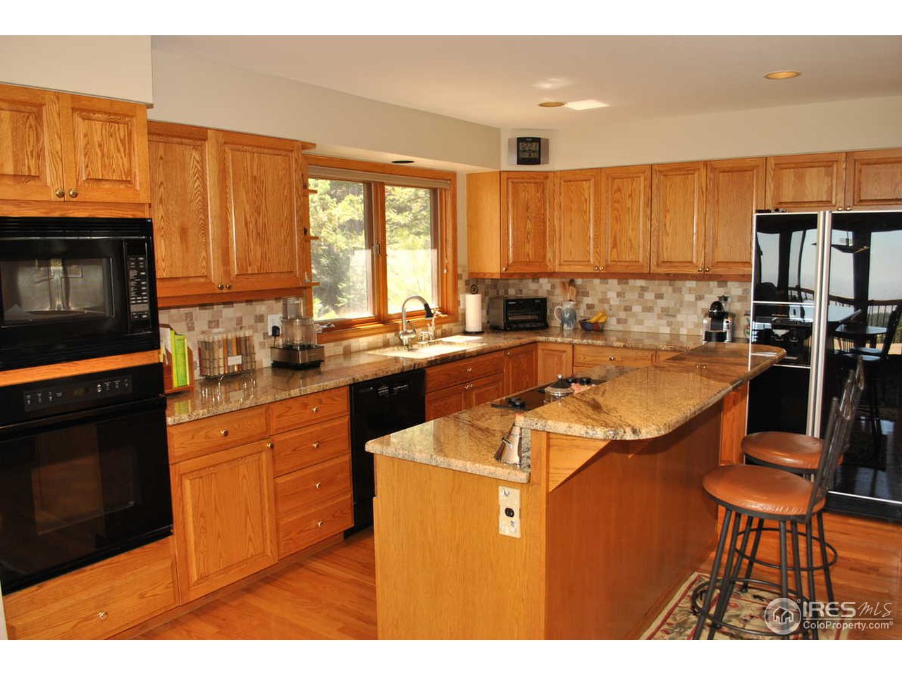 716 Brook Road Boulder, CO 80302 - Photo 13 of 25 a kitchen with a sink stove and microwave