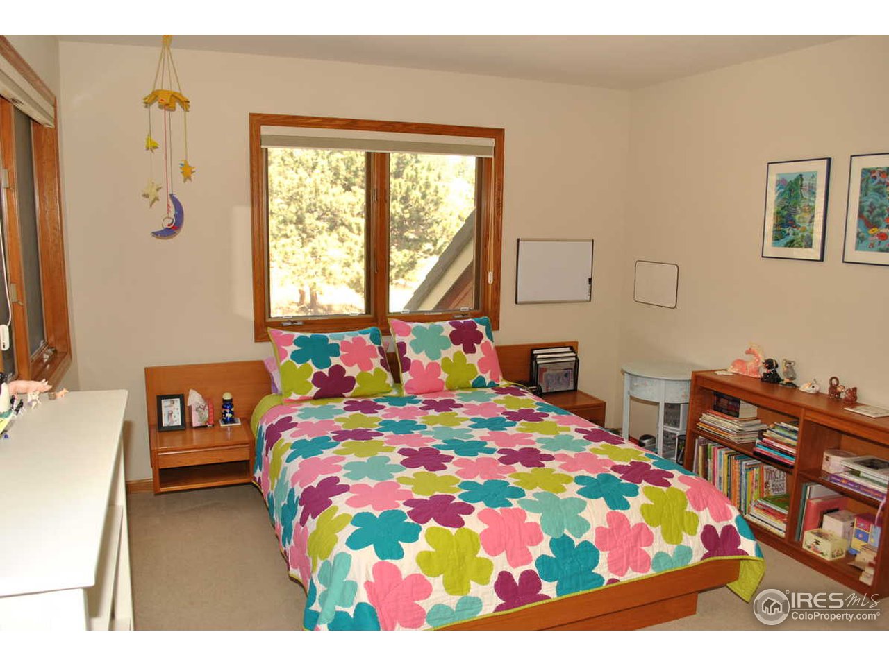 716 Brook Road Boulder, CO 80302 - Photo 20 of 25 a bedroom with a bed and a dresser in it