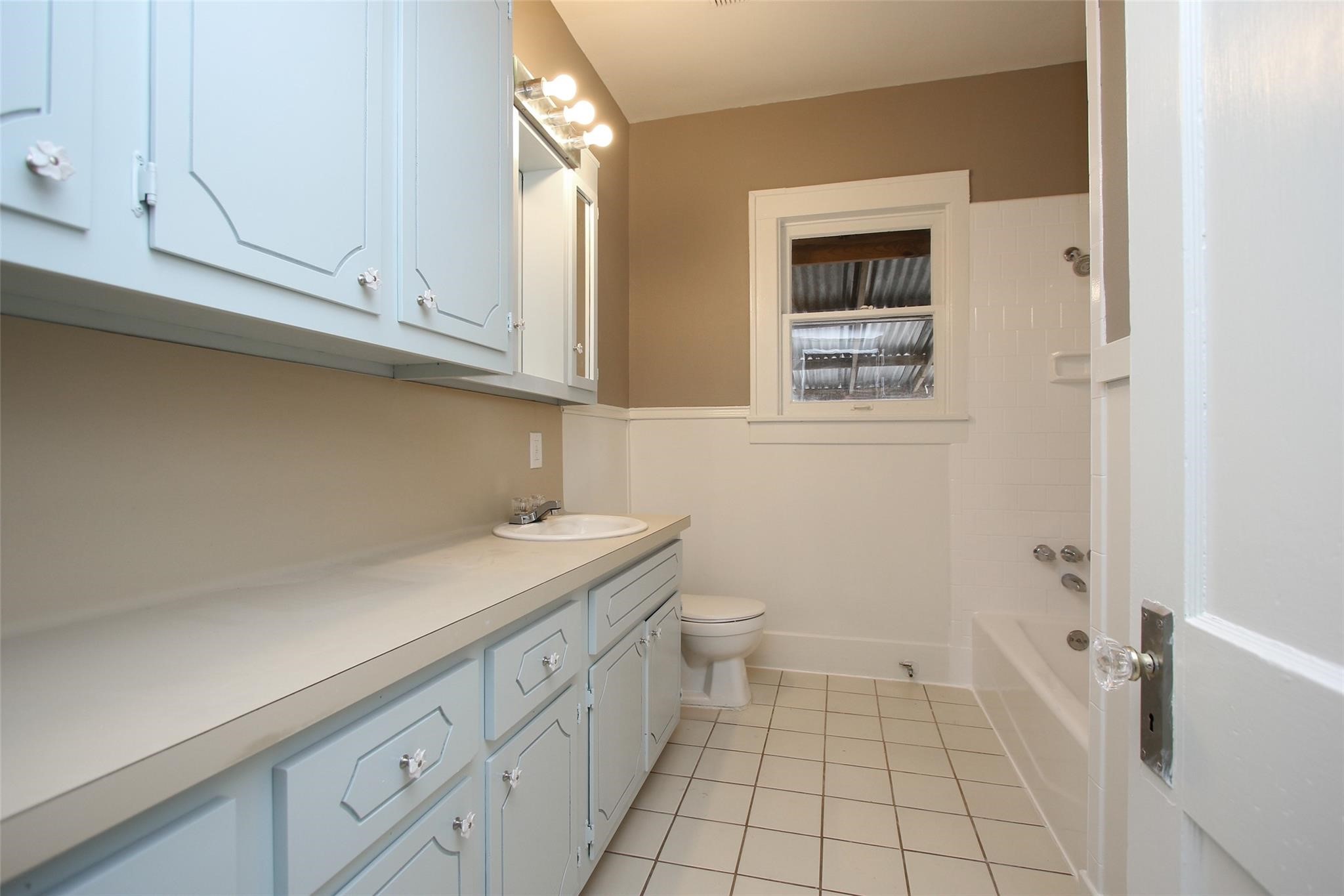 1127 Walling Street Houston, TX 77009 - Photo 19 of 23 a bathroom with a sink a toilet and vanity