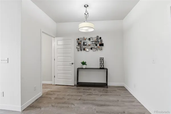 a view of a hallway with entryway and chandelier